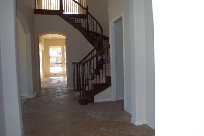 Stairs stained and with tile in the front hall